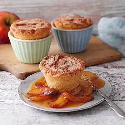 Kleine Puddingformen mit Soufflé und Birnenkompott.