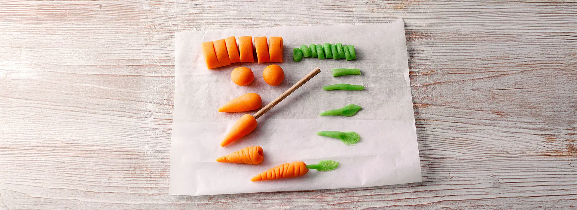 Kleine Karotten aus Marzipan geformt.
